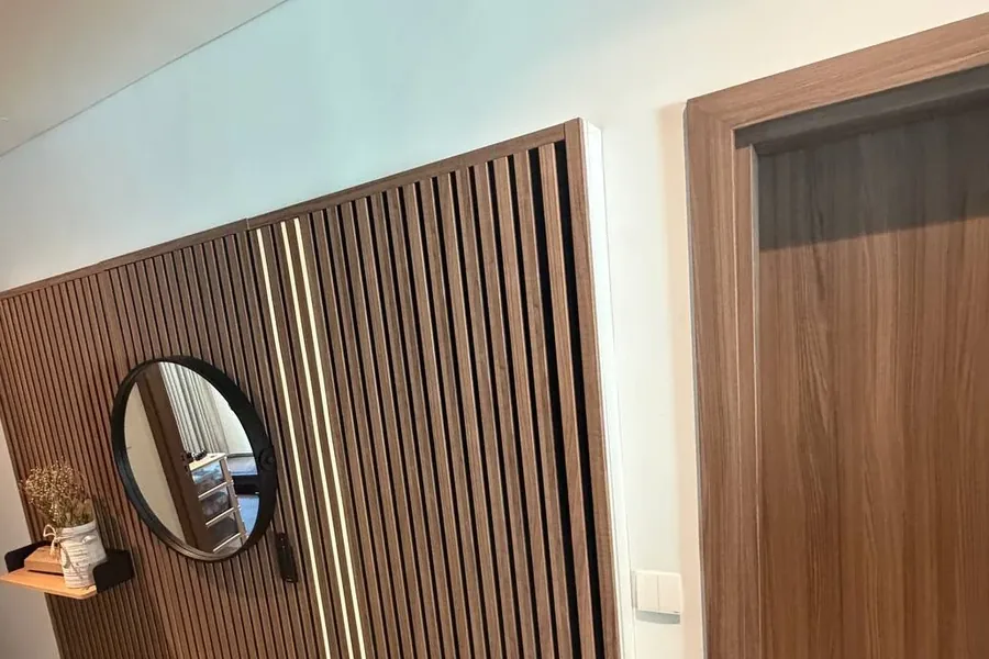Slatted wall panel with integrated LED lighting in a hallway