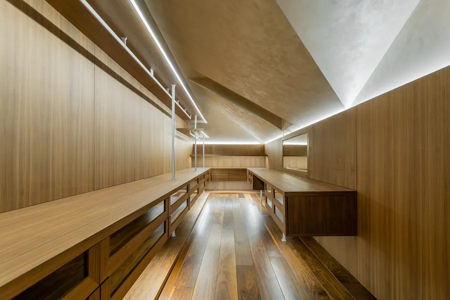 Walnut built-in joinery with integrated linear lighting